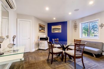 a dining room with a table and chairs and a living room at 500 Fifth Apartments, Nashville, 37219
